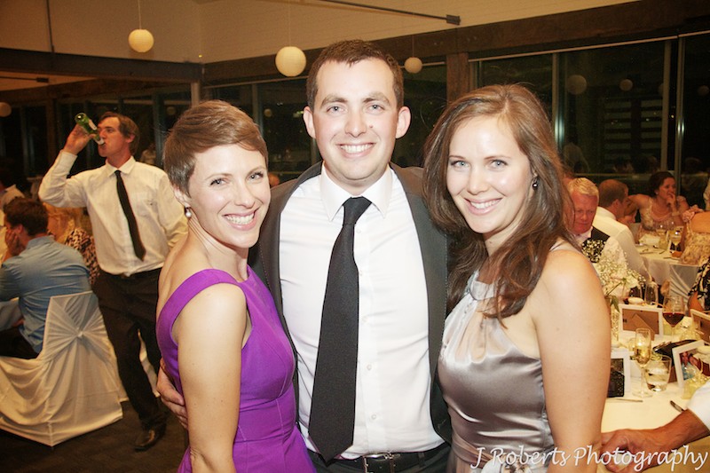 Groom with his sisters at wedding reception - wedding photography sydney